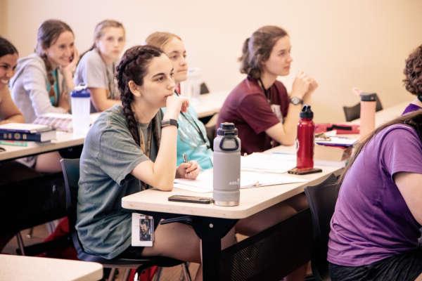 Students taking notes in a classroom