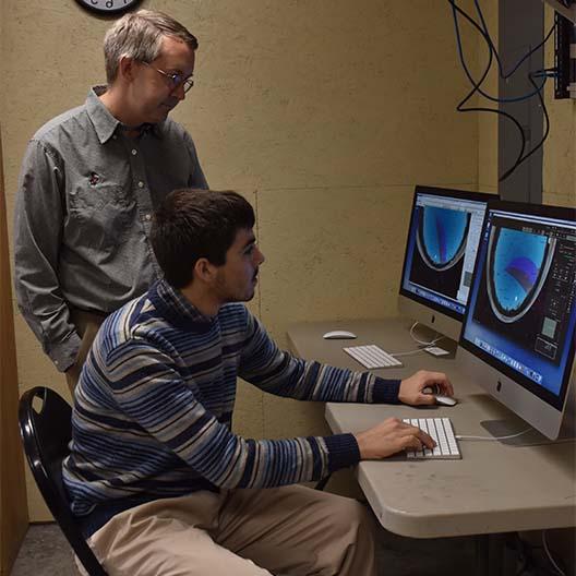 Dr. Maderak assists a student in the Daglen Observatory 