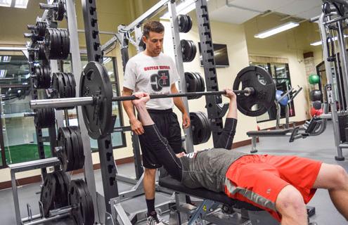 Personal Trainer spotting a weightlifter