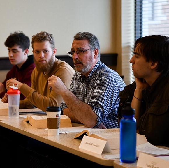 Dr. Jean Rioux with students in a seminar class